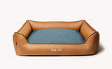 Designer dog bed, made from beige leather and blue woven fabric