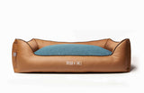 Medium bolster memory foam dog bed, made from beige leather and blue woven fabric