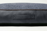 Grey dog mattrass bed with handle made from leather and woven fabric